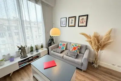 a living room with a couch and a table at Beautiful studio apartment just a stone's throw from the beach in Nice