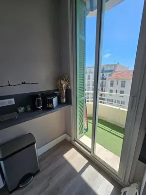 a room with a window with a view of a yard at Beautiful studio apartment just a stone's throw from the beach in Nice