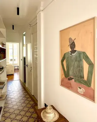 a painting of a man in a hat on a wall at Un cocon en centre ville de Nice 2 personnes in Nice