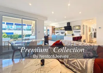 a living room with a couch and a kitchen at Nestor&Jeeves - TERRASSE D OR - By sea - Terrace in Nice