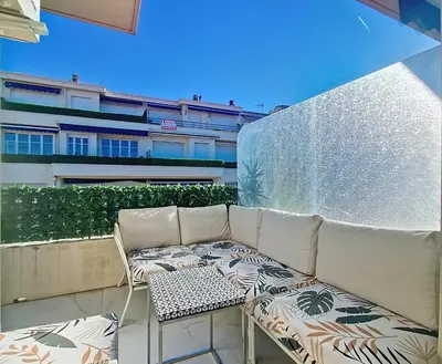 a couch and a chair on a balcony at Nestor&Jeeves - TERRASSE D OR - By sea - Terrace in Nice