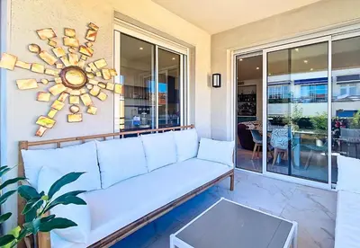 a living room with a couch and a large window at Nestor&Jeeves - TERRASSE D OR - By sea - Terrace in Nice