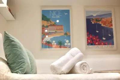 a living room with a couch with towels on it at Studio de charme - Vieille Ville - Proche plage in Villefranche-sur-Mer