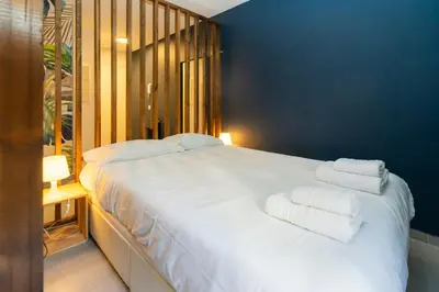 a bedroom with a large white bed with towels on it at Victoria 2 People Parking AC WiFi in Nice