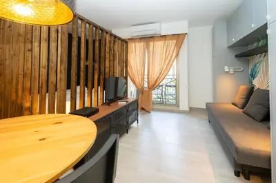 a living room with a table and a couch at Victoria 2 People Parking AC WiFi in Nice