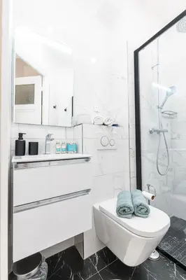 a white bathroom with a toilet and a shower at MY CASA - VERDI - Superb Studio Suite City Center in Nice