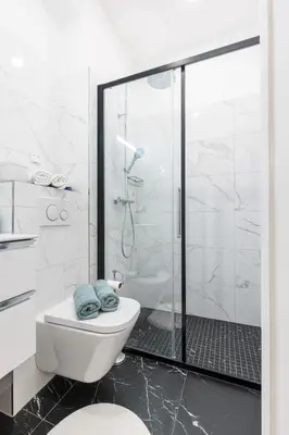 a white bathroom with a shower and a toilet at MY CASA - VERDI - Superb Studio Suite City Center in Nice