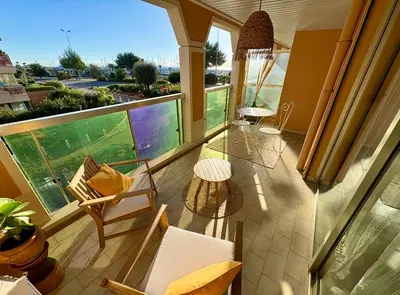 a balcony with chairs and a table and a view at Studio cosy - Vue mer - Terrasse - Parking in Saint-Laurent-du-Var