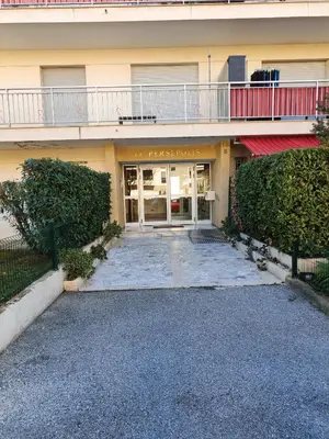 a building with a parking lot in front of it at T2 douillet proche de Nice - Accès plage à pied in Cagnes-sur-Mer