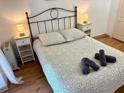 a bedroom with a bed with two pairs of shoes on it at Parenthèse Niçoise - Cœur de Nice in Nice
