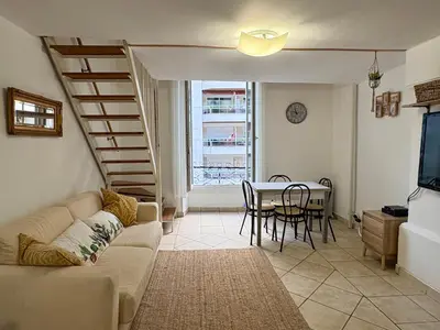 a living room with a couch and a table at Parenthèse Niçoise - Cœur de Nice in Nice