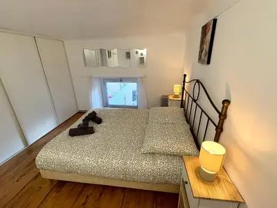 a bedroom with a bed with a teddy bear on it at Parenthèse Niçoise - Cœur de Nice in Nice