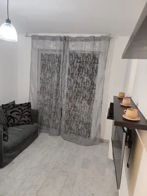 a living room with a couch and a window at Bel appartement in Nice