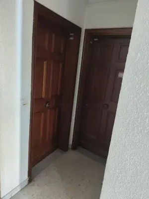 two brown doors in a room with a wall at Bel appartement in Nice