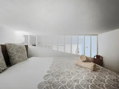 a bedroom with a large bed with a pillow on it at Studio moderne et douillet au cœur de Nice in Nice