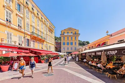 a group of people walking down a street with buildings at Studio moderne et douillet au cœur de Nice in Nice