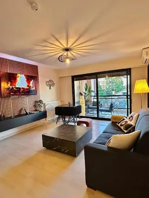 a living room with a couch and a piano at Appartement moderne climatisé avec piscine, terrasse et parking - Proche Promenade des Anglais in Nice