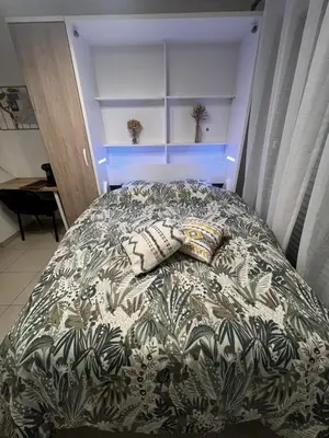 a bed with two pillows on it in a bedroom at Cœur Libération Nice Studio in Nice