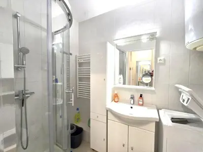 a bathroom with a shower and a sink and a mirror at Cœur Libération Nice Studio in Nice
