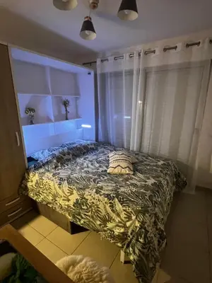a bedroom with a bed with a floral bedspread at Cœur Libération Nice Studio in Nice