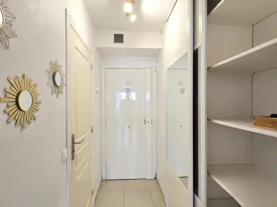 a hallway with a white door and a mirror at Cœur Libération Nice Studio in Nice