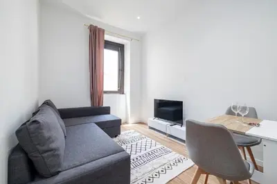 a living room with a couch and a table at Au cœur de Nice, Gare à pied et Climatisation in Nice