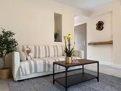 a living room with a couch and a table at Oscar II in Nice