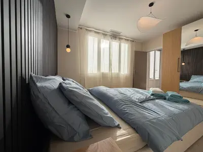 a bedroom with a large bed with pillows on it at Oscar II in Nice
