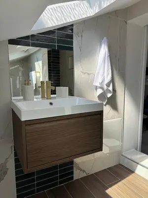 a bathroom with a sink and a mirror at Cocon lumineux sous les toits de Nice in Nice