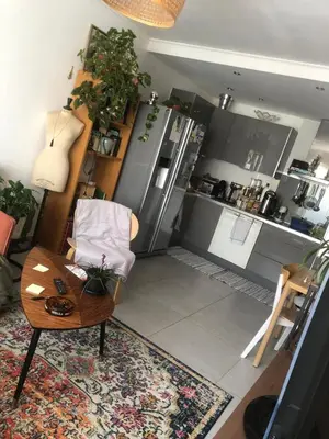 a living room with a table and a kitchen at Port of Nice Terrace Apartment in Nice