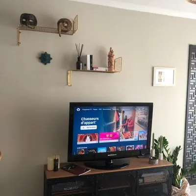 a flat screen tv sitting on top of a wooden stand at Port of Nice Terrace Apartment in Nice