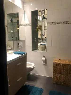 a bathroom with a toilet and a sink and a mirror at Port of Nice Terrace Apartment in Nice