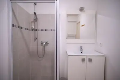 a bathroom with a shower and a sink and a mirror at Bail mobilité - Beau studio proche tram Saint-Roch in Nice