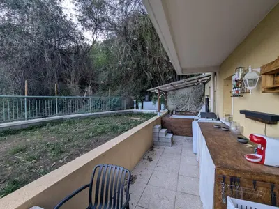 a patio with a table and chairs on a balcony at Nice Cosy Garden in Nice