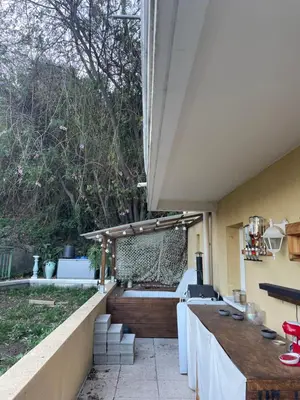 an outdoor patio with a table and chairs at Nice Cosy Garden in Nice