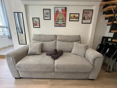 a living room with a couch and a staircase at Studio Rio - Jean Médecin - La Riviera LCD in Nice