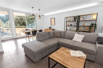 a living room with a couch and a table at Le Pin - Peaceful - Parking - Comfort - AC in Saint-Laurent-du-Var