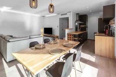 a dining room with a wooden table and chairs at Le Pin - Peaceful - Parking - Comfort - AC in Saint-Laurent-du-Var