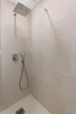 a shower in a white bathroom with a shower at Le Pin - Peaceful - Parking - Comfort - AC in Saint-Laurent-du-Var
