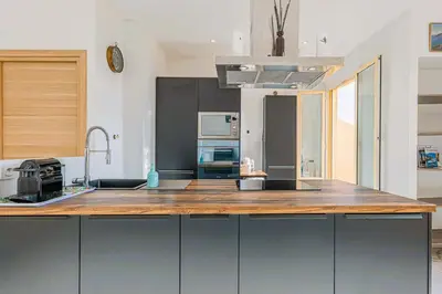 a kitchen with a large wooden counter top at Bail mobilité - Appartement 2 ch - Nice centre in Nice