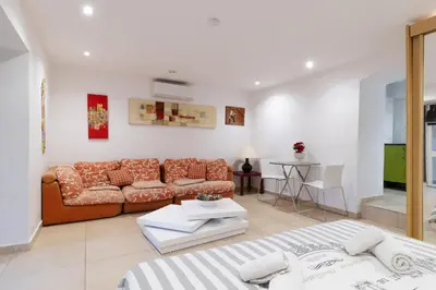 a living room with a couch and a table at Studio indépendant en villa Calme, Jardins et Piscine à 5 min de la Mer in Nice