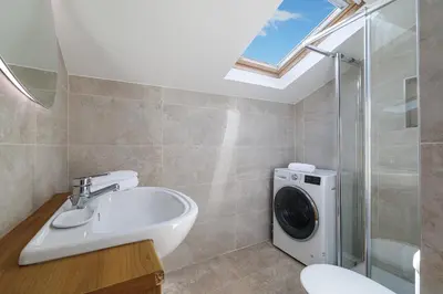 a bathroom with a sink and a washing machine at Duplex à 2 min de la mer à pied in Nice