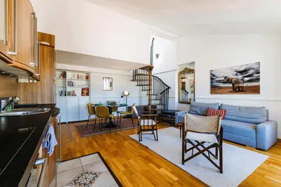 a kitchen and living room with a blue couch at Duplex à 2 min de la mer à pied in Nice