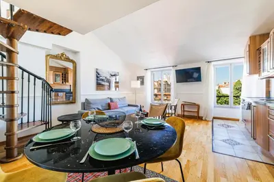 a kitchen and living room with a table and chairs at Duplex à 2 min de la mer à pied in Nice