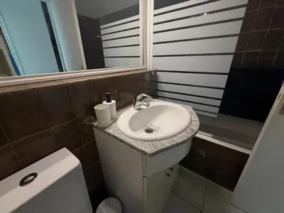 a bathroom with a white sink and a toilet at La Casa di Gio studio Cosy Tram et mer in Nice