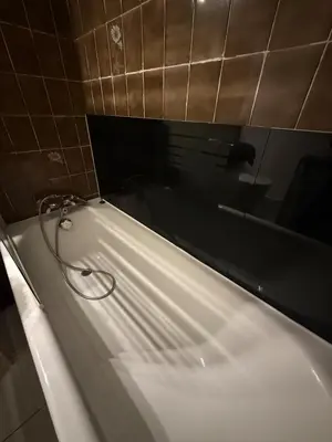 a bath tub with a hose in a bathroom at La Casa di Gio studio Cosy Tram et mer in Nice