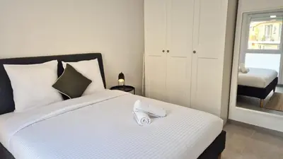 a bedroom with a bed with a towel on it at T3 neuf climatisé avec parking à Nice in Nice