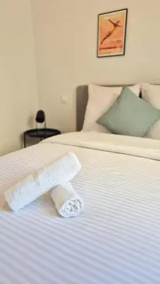 a roll of toilet paper on a bed at T3 neuf climatisé avec parking à Nice in Nice