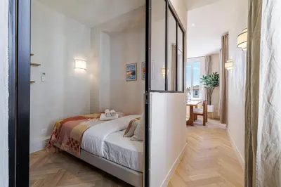 a small bedroom with a bed in a room at 62 CARNOT LOT 5 - Appartement renove - climatise 2 chambres suites in Nice