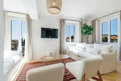 a living room with white furniture and windows at 62 CARNOT LOT 7 - Appartement Duplex Atypique- climatise - 2 chambres in Nice